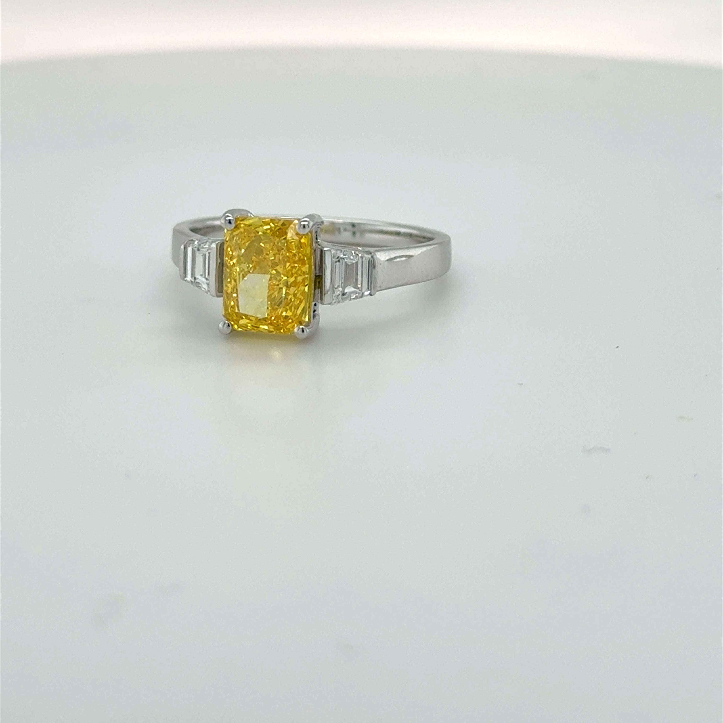3 carat center Radiant Famcy yellow  E vs igi certified with tapper baguette cut on side made with high craftsmanship with round brilliance ( made in 14k gold)