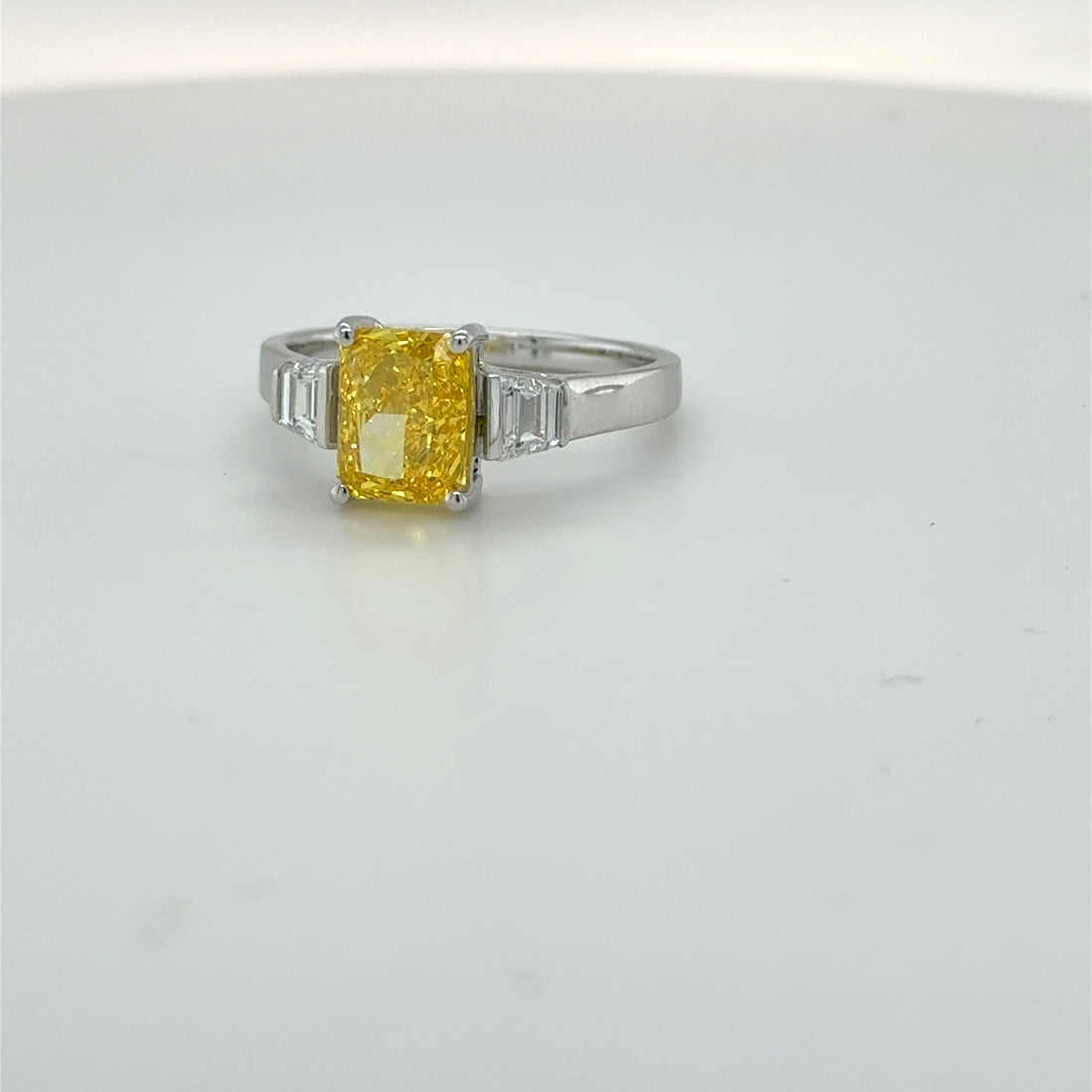 3 carat center Radiant Famcy yellow  E vs igi certified with tapper baguette cut on side made with high craftsmanship with round brilliance ( made in 14k gold)