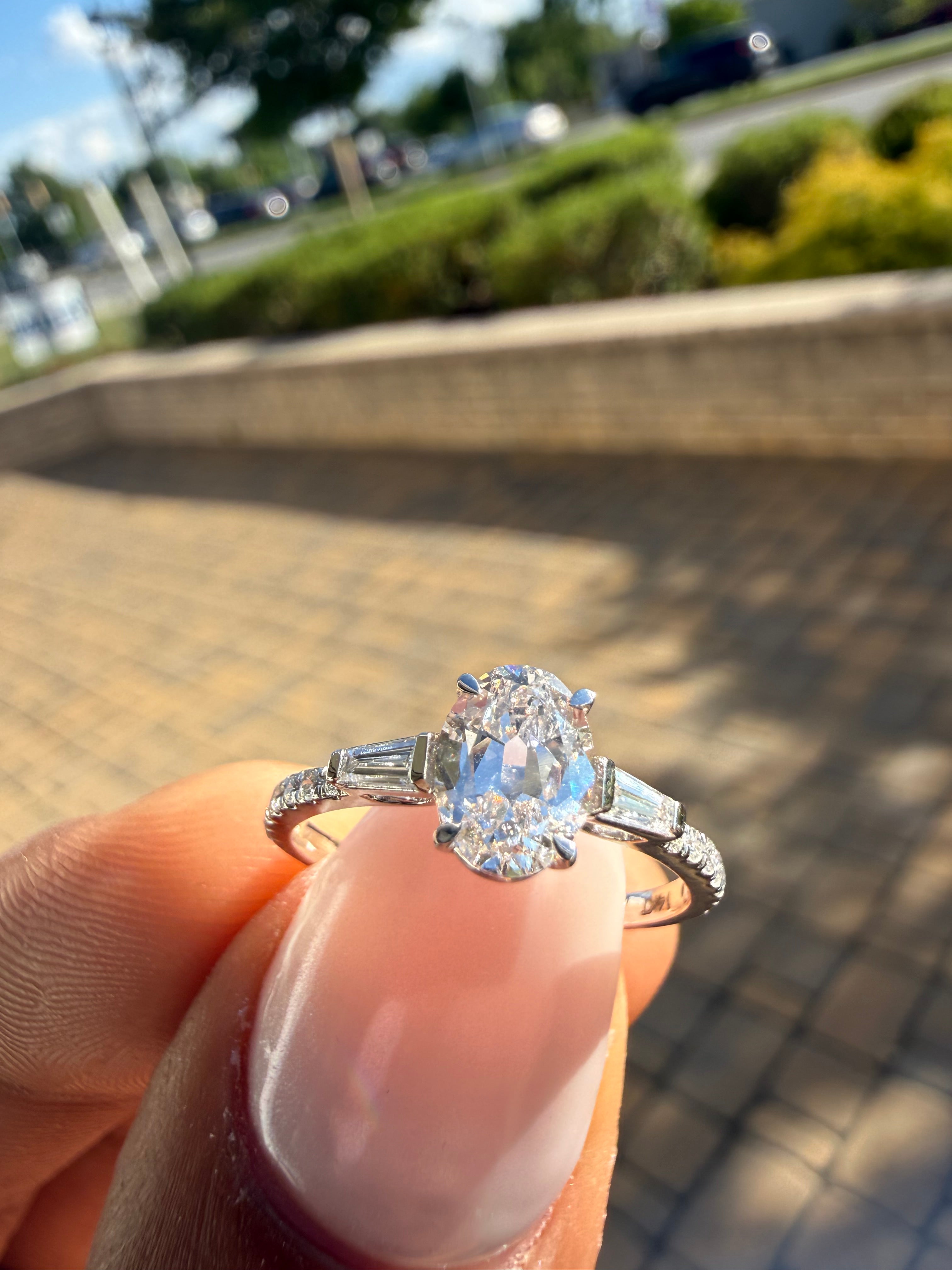 1.5 carat oval cut ring cut E vs IGI certified with special cut baguette on side highly handcrafted in grown diamond 14k gold