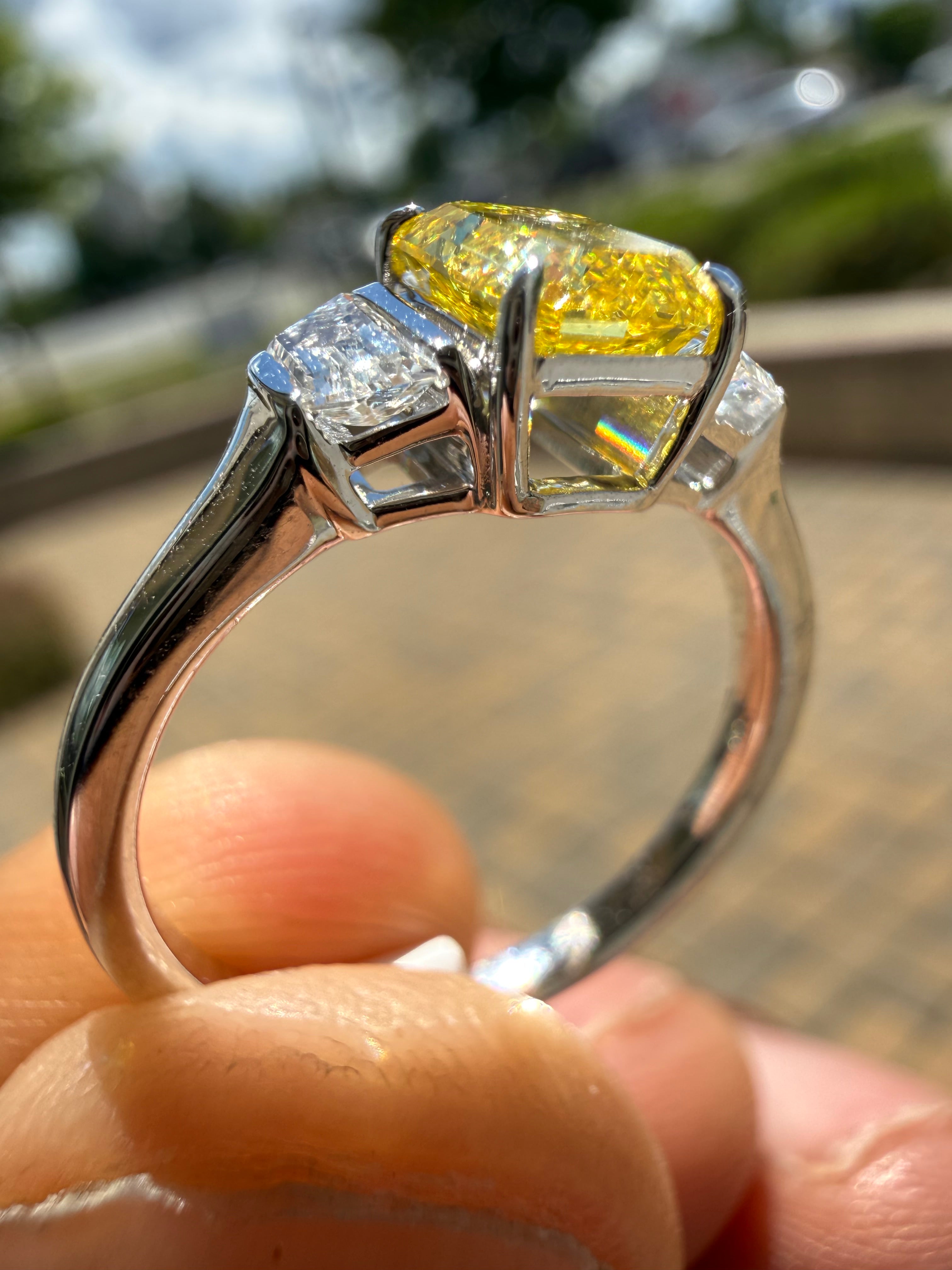 1.5 carat  Emerald cut center stone fancy yellow emerald cut ring in fancy vivid yellow igi certified VS stone with special cut side stones on side handcrafted in color high cut with  handcrafted ring made with 14k gold in grown diamond igi certified