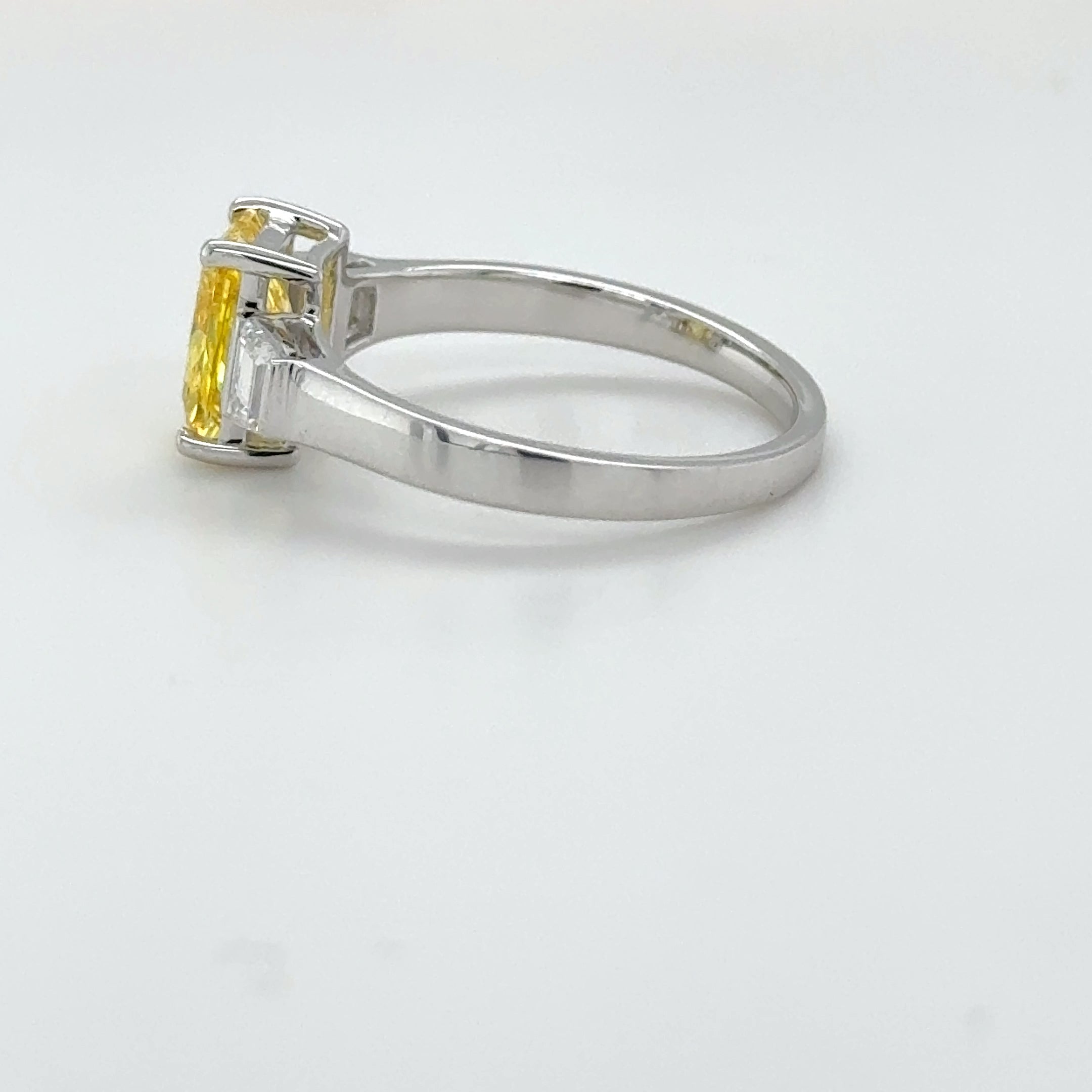 3 carat center Radiant Famcy yellow  E vs igi certified with tapper baguette cut on side made with high craftsmanship with round brilliance ( made in 14k gold)
