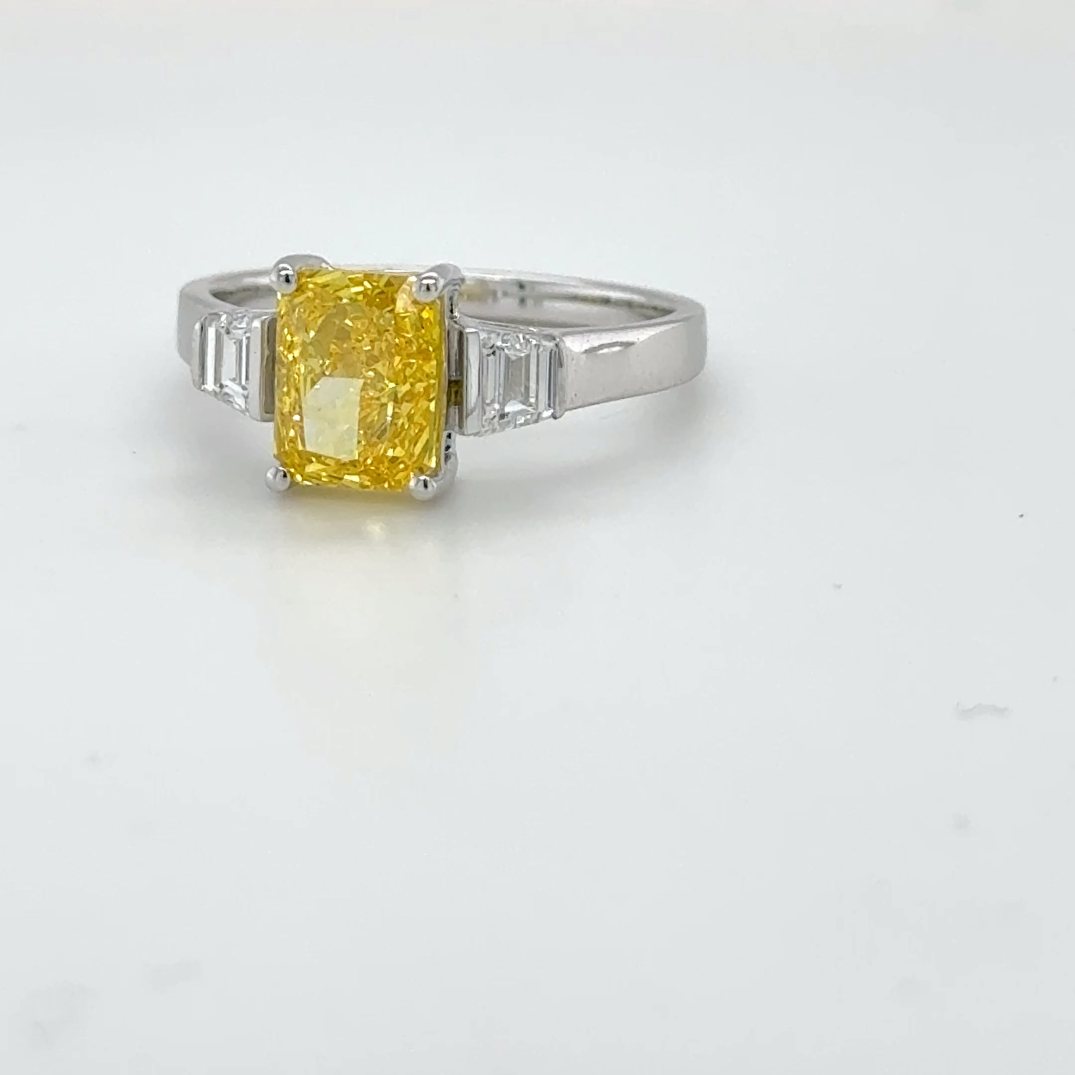 3 carat center Radiant Famcy yellow  E vs igi certified with tapper baguette cut on side made with high craftsmanship with round brilliance ( made in 14k gold)