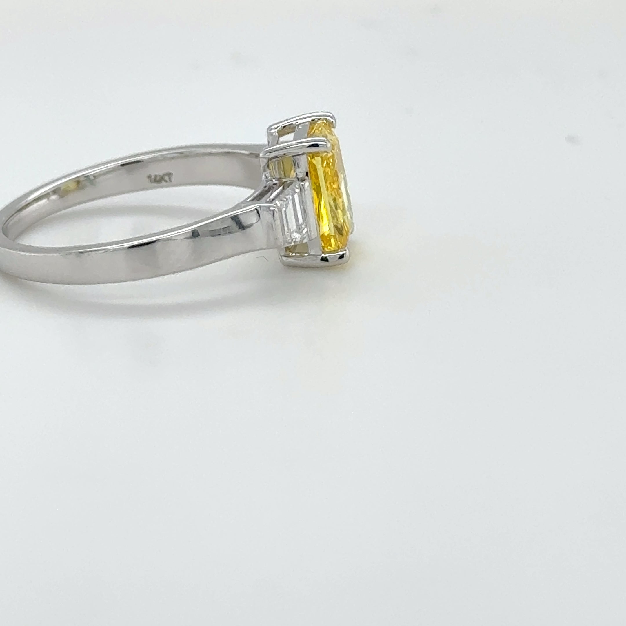 3 carat center Radiant Famcy yellow  E vs igi certified with tapper baguette cut on side made with high craftsmanship with round brilliance ( made in 14k gold)