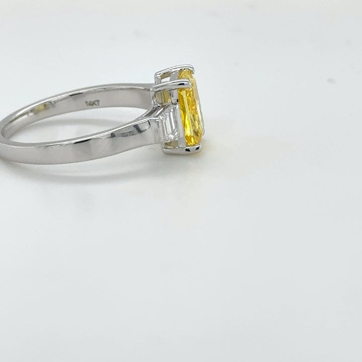 3 carat center Radiant Famcy yellow  E vs igi certified with tapper baguette cut on side made with high craftsmanship with round brilliance ( made in 14k gold)