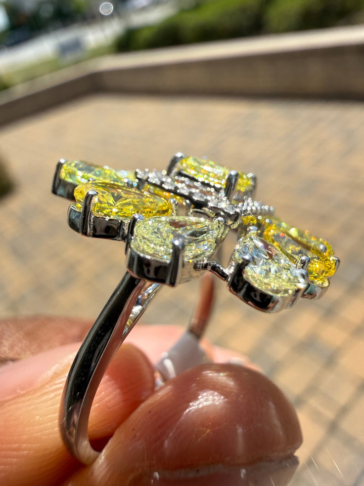 5 carat fancy yellow oval with center princess cut ring in fancy vivid yellow igi certified center stone with special cut side stones on side handcrafted in color high cut with  handcrafted ring made with 14k gold in grown diamond igi certified
