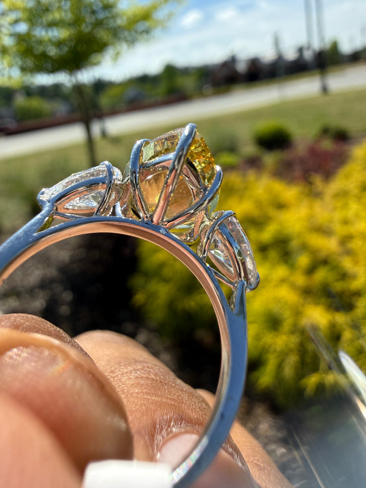 6.5  carat ring with fancy vivid yellow igi certified stone ehandcrafted in color high cut with fancy 2 pear on side stone in  ring handcrafted ring made with 14k gold in grown diamond igi certified