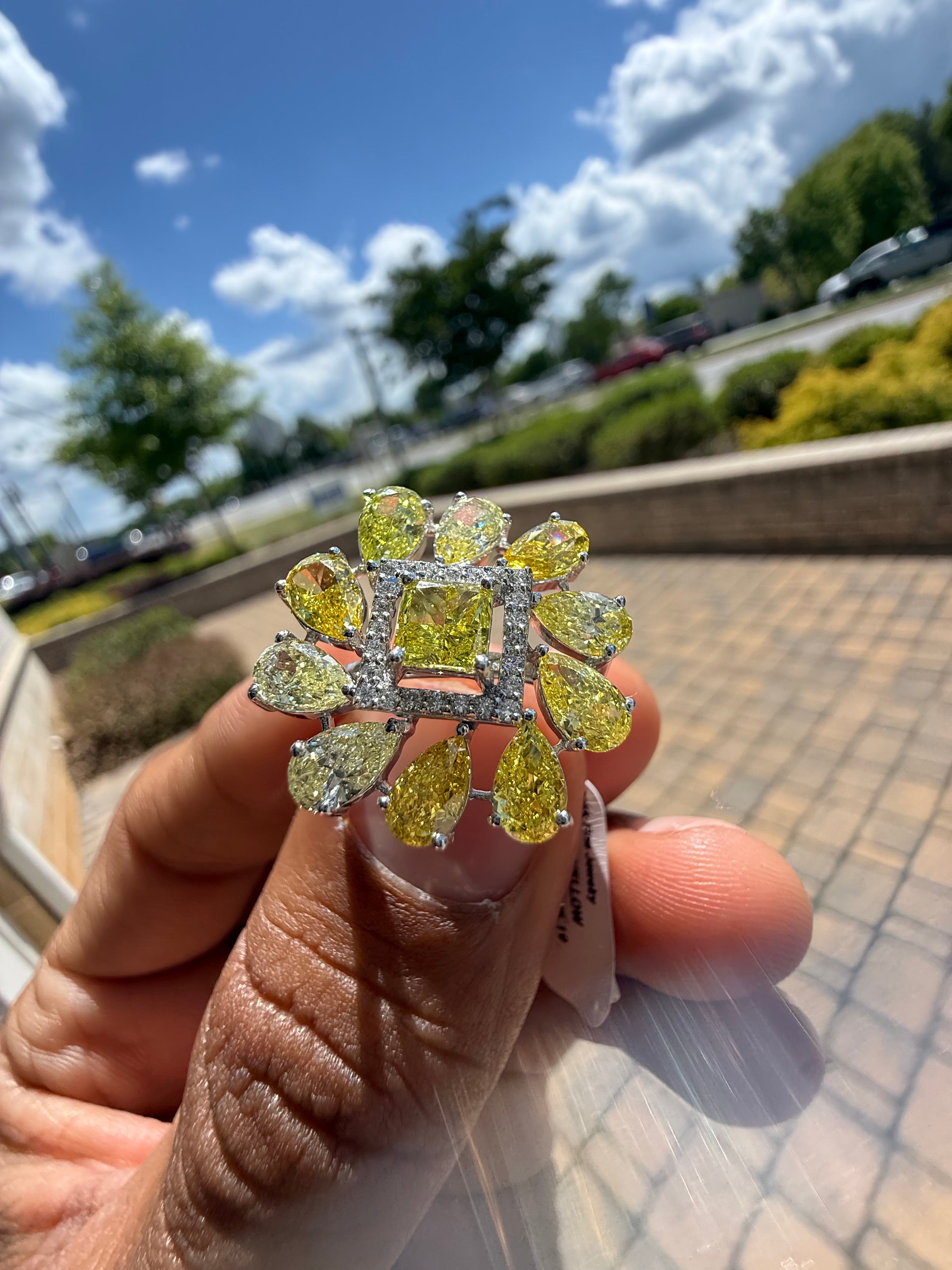 5 carat fancy yellow oval with center princess cut ring in fancy vivid yellow igi certified center stone with special cut side stones on side handcrafted in color high cut with  handcrafted ring made with 14k gold in grown diamond igi certified