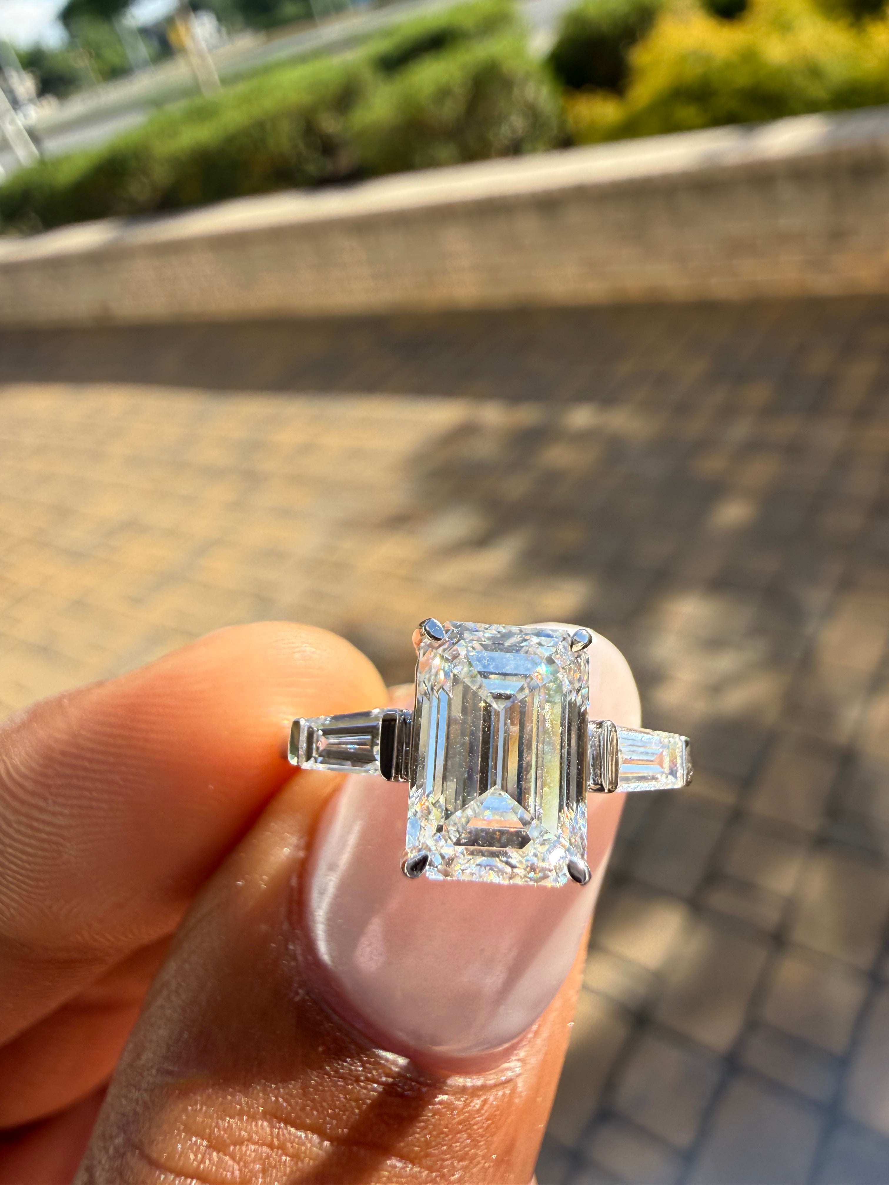 3.75 carat ring emerald cut ring cut E vs IGI certified 3 carat center stone with special cut tapper baguette on side highly handcrafted in grown diamond 14k gold