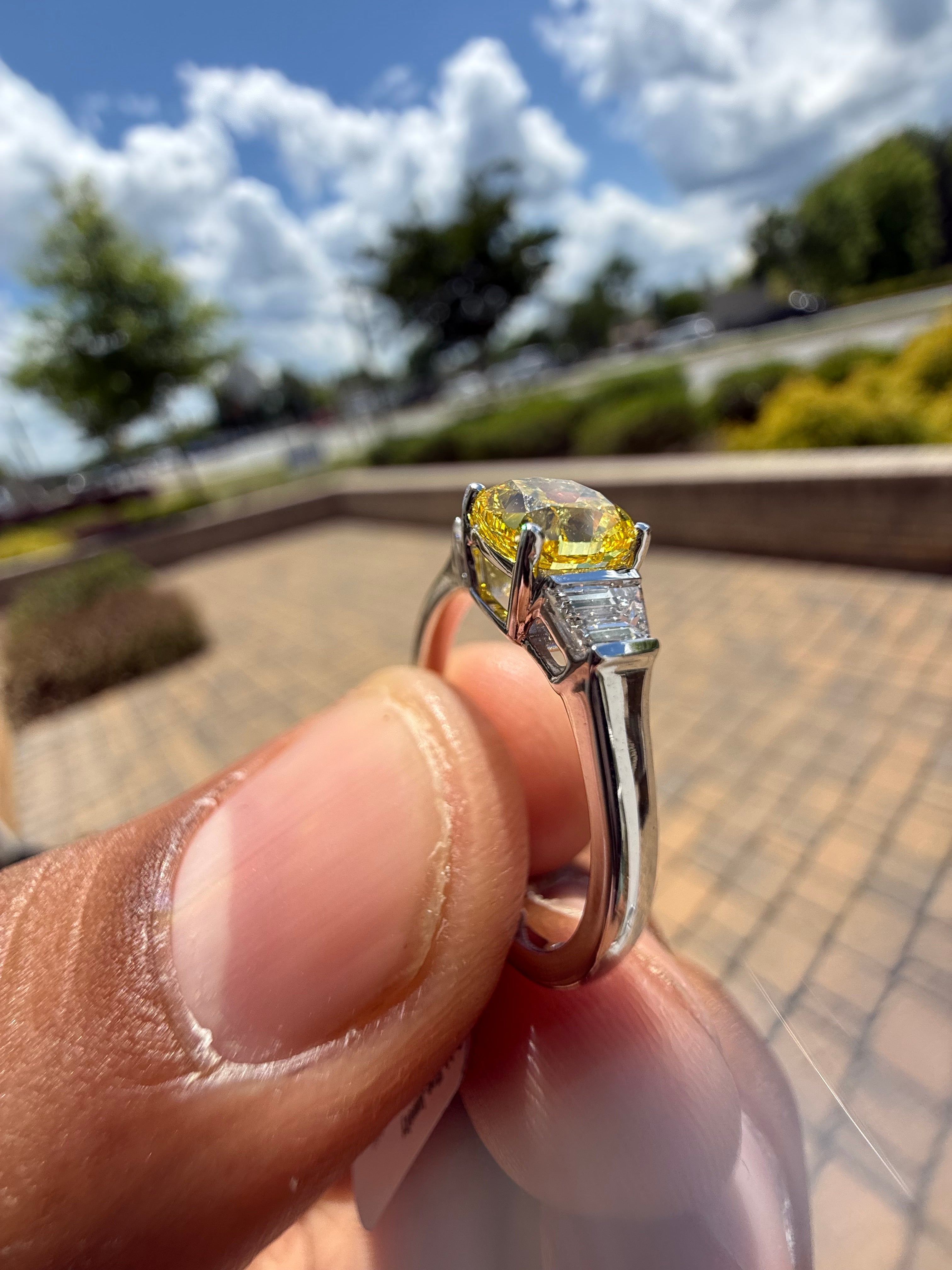 1.5 carat  cushion center stone fancy yellow emerald cut ring in fancy vivid yellow igi certified stone handcrafted in color high cut with  handcrafted ring made with 14k gold in grown diamond igi certified
