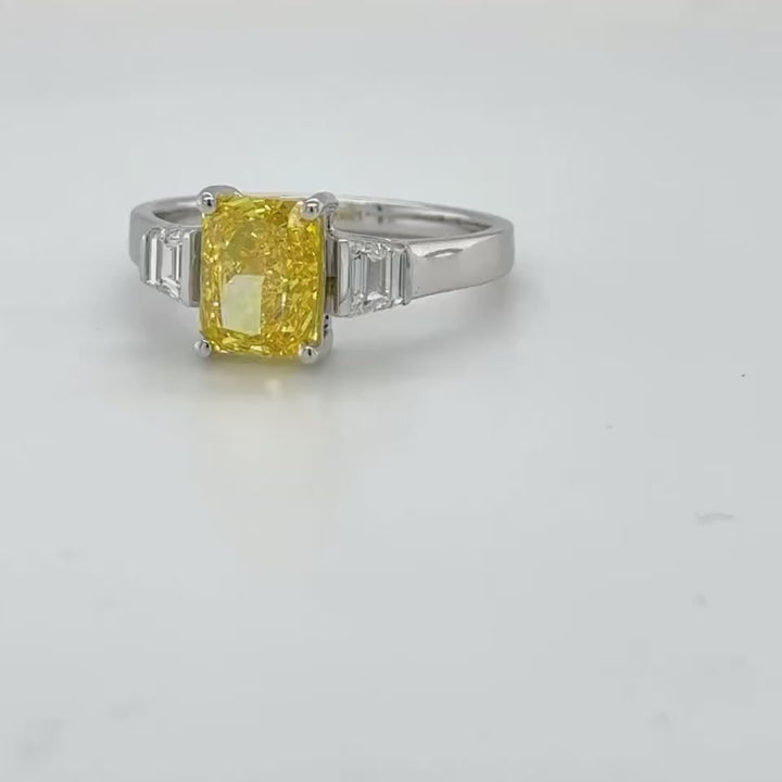3 carat center Radiant Famcy yellow  E vs igi certified with tapper baguette cut on side made with high craftsmanship with round brilliance ( made in 14k gold)